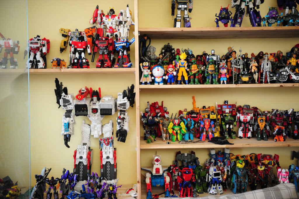 A collection of Transformers robots arranged in a wooden display