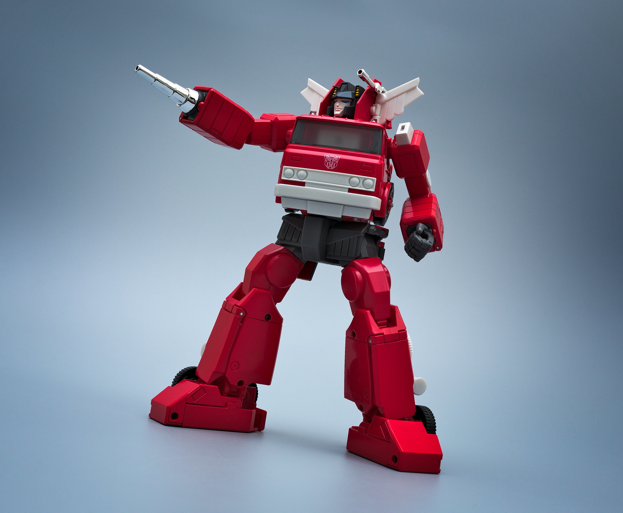 Autobot Inferno with a silver wrist barrel attachment in replacement of his right fist