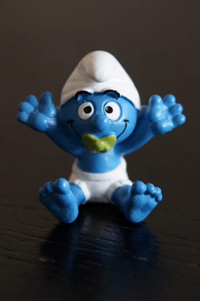 Baby Smurf wearing a diaper and a light green pacifier