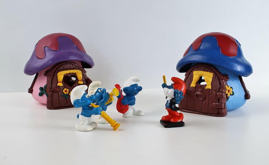 Three Harmony Smurfs playing different instruments in from of Conductor Papa Smurf