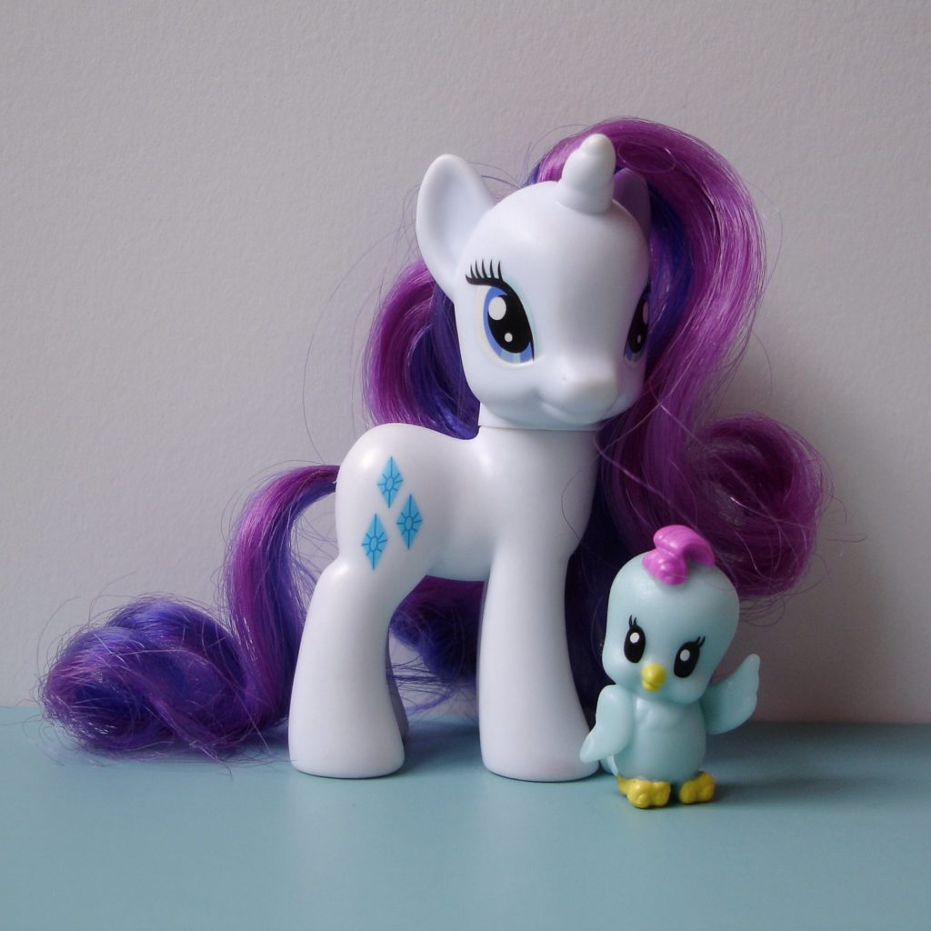 A white unicorn Rarity with a curled violet mane and tail and three diamonds marked on her hips