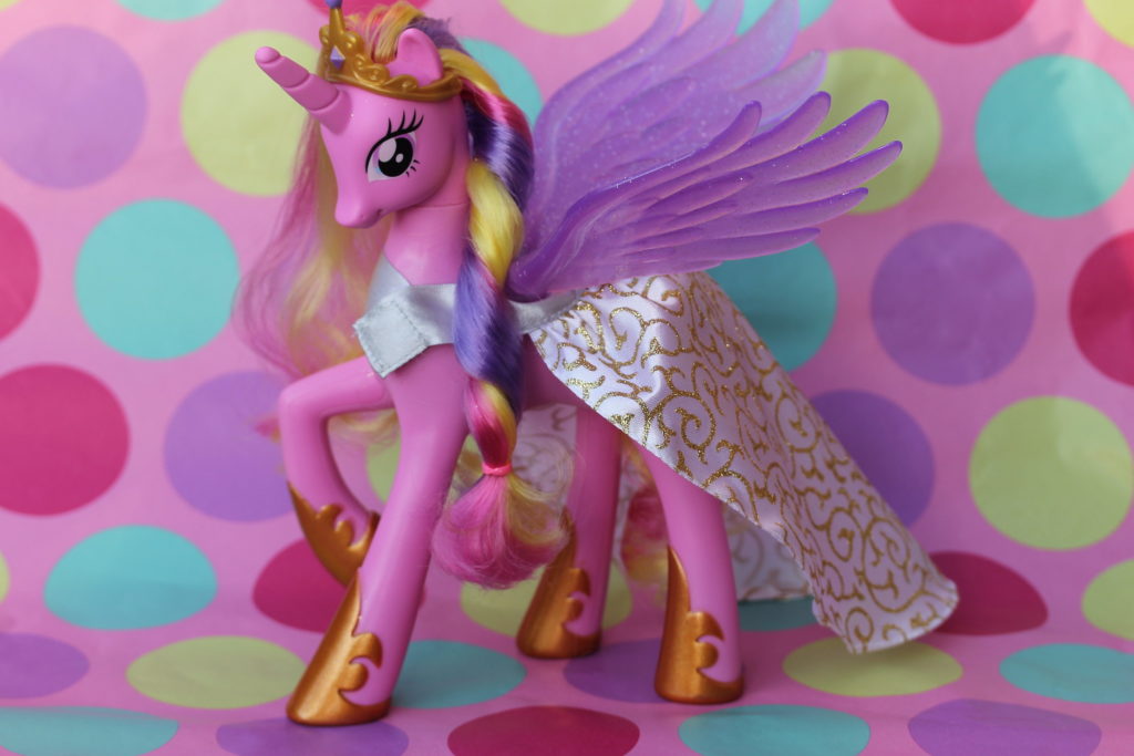 A purple Princess pony with a long horn, golden crown and shoes, purple wings