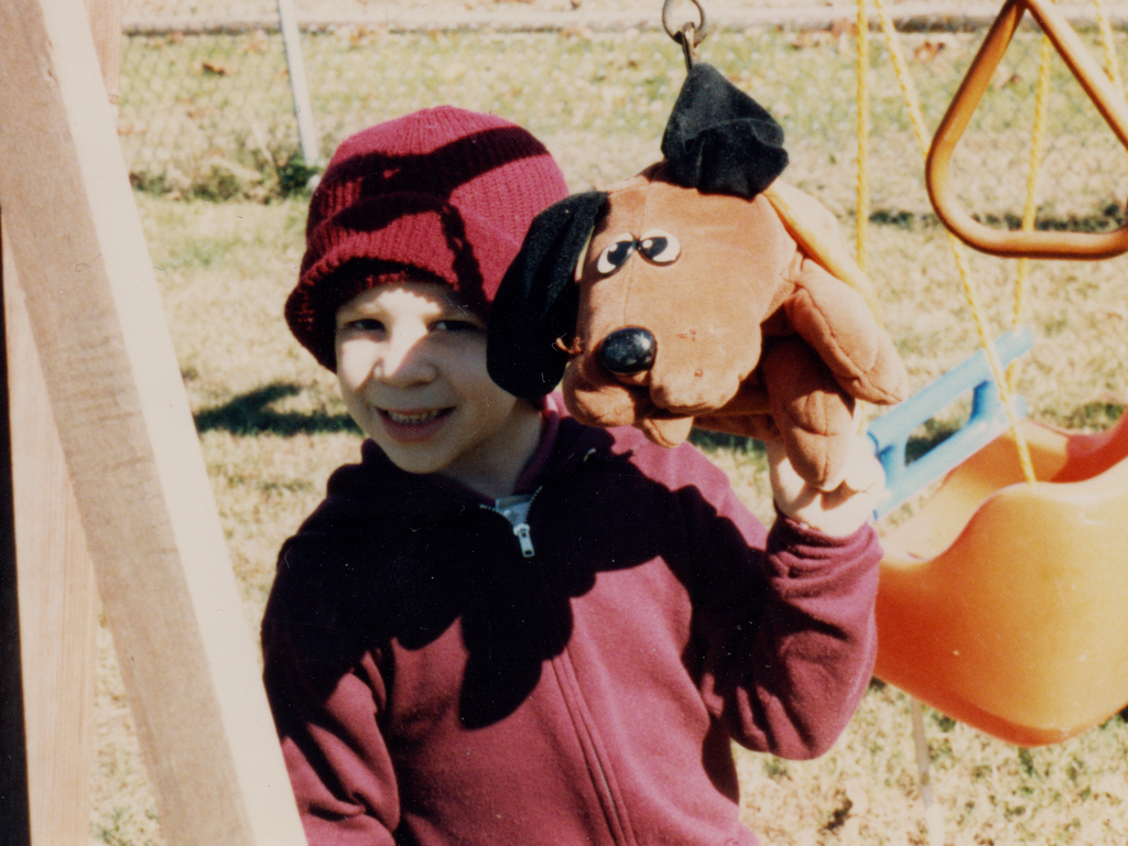 Little boy holding a pound puppy toy