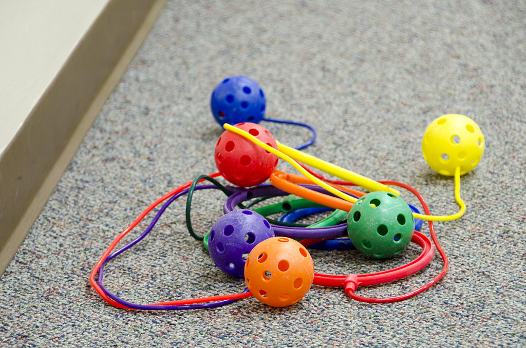 colorful skip-it toys on the floor