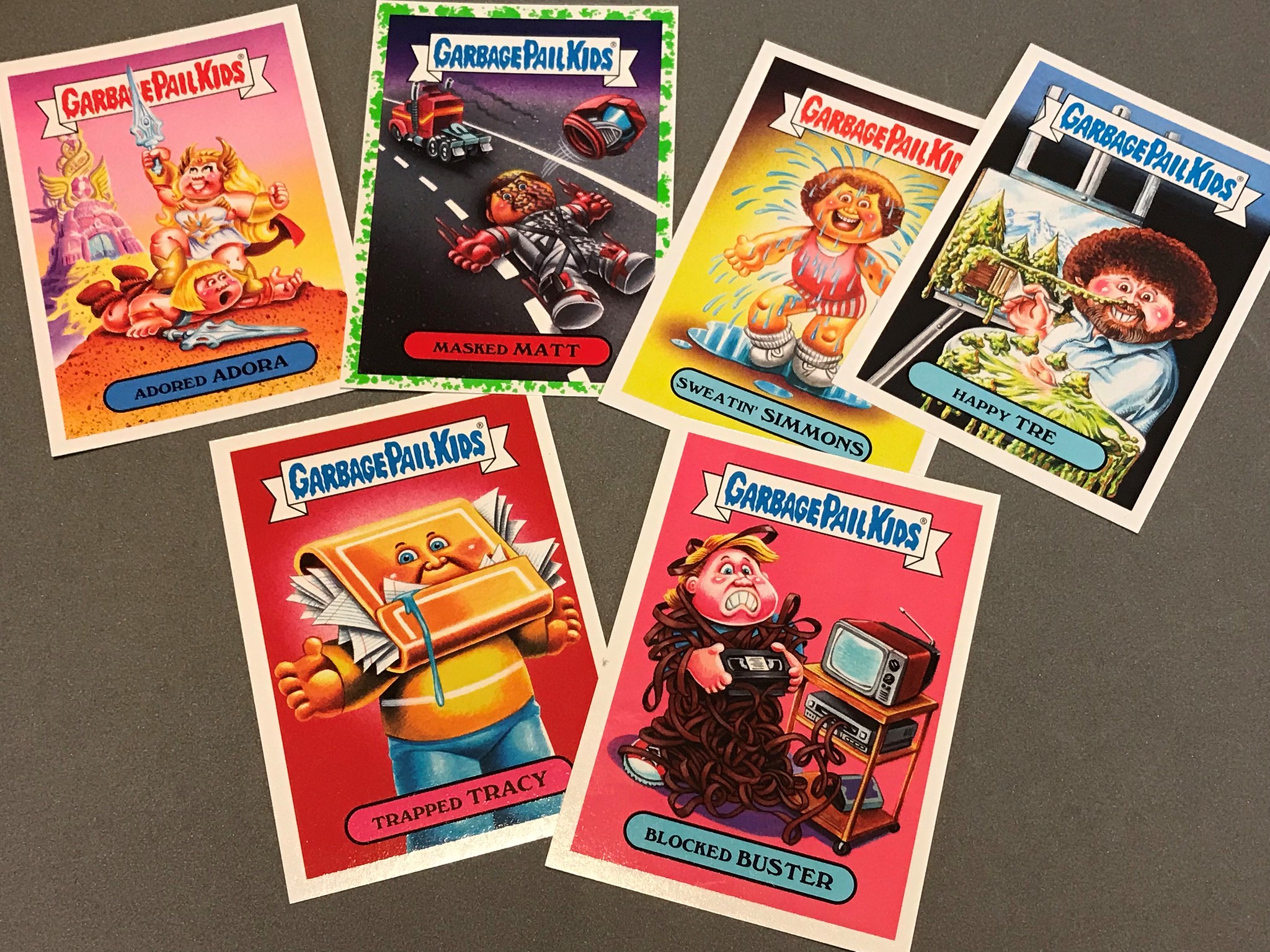 six Garbage Pail Kids cards laid out