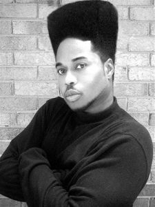 A man with a high top fade hairstyle