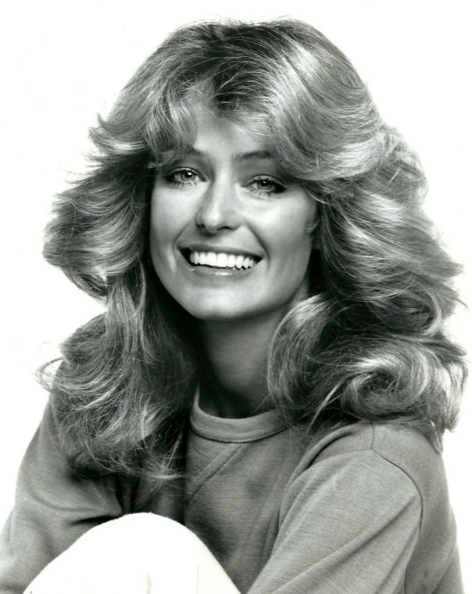 A smiling woman with a Feathery Farah Fawcett hairstyle