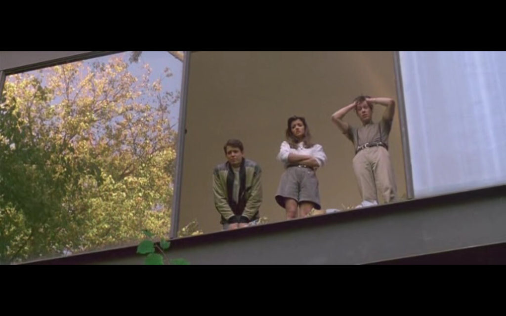 Ferris, Cameron, and Sloane looking down from a large broken window at Cameron’s house.