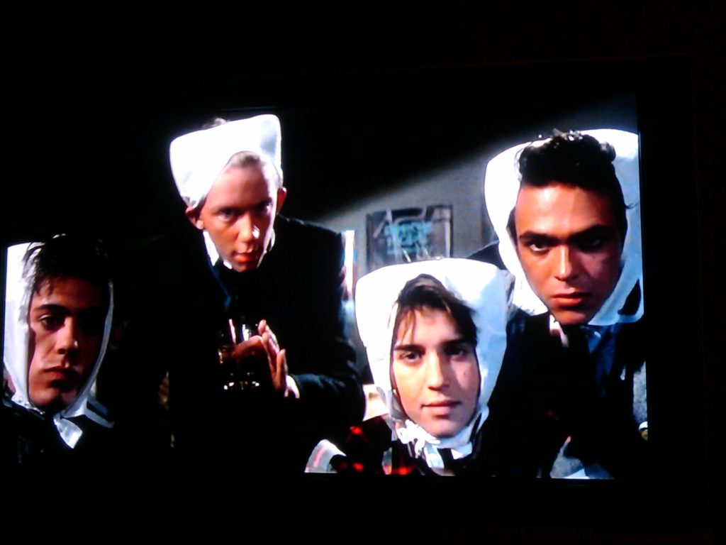 Four characters from Weird Science wearing bras on their heads.