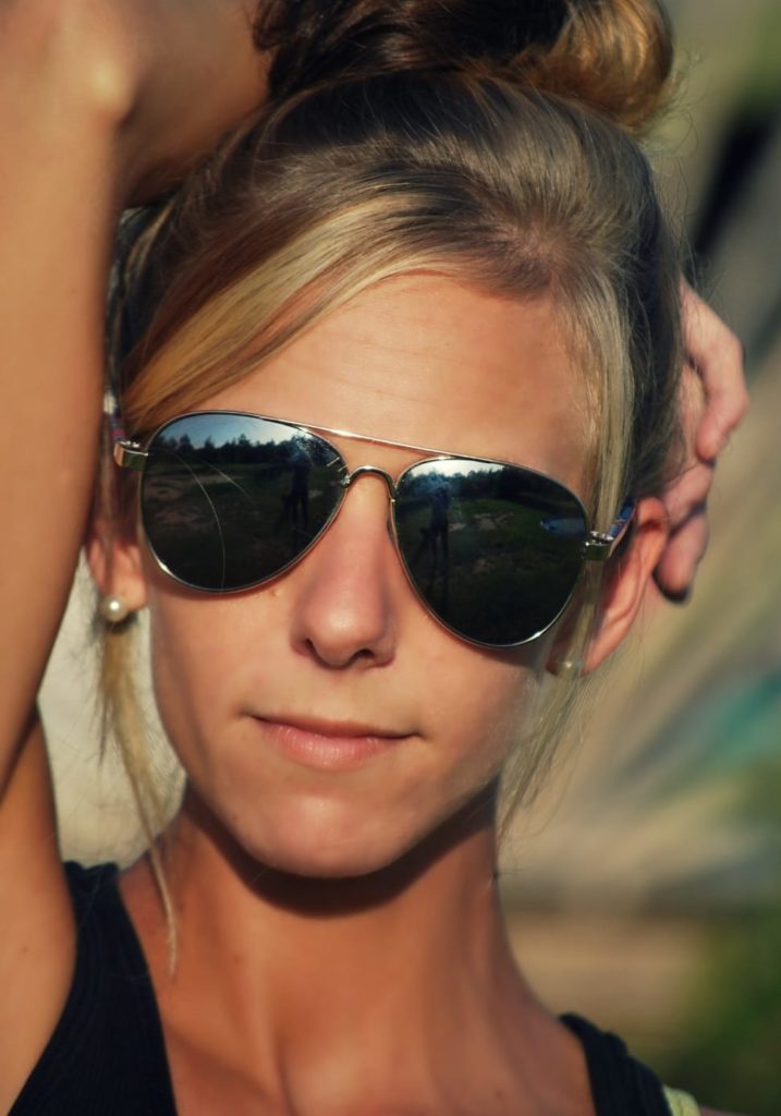 A muscular woman wearing an aviator sunglasses