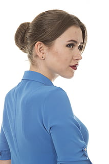 A woman wearing a blue office blouse with big sleeves