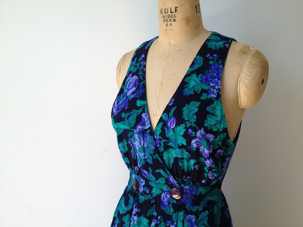 A blue and green floral dress displayed on a mannequin