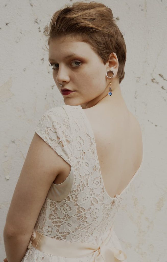 A woman wearing a cream lace dress