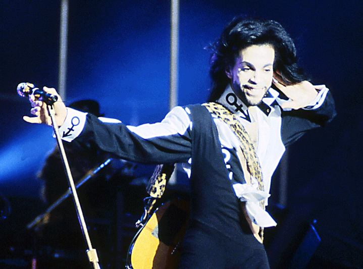 Singer Prince holding mic attached to stand