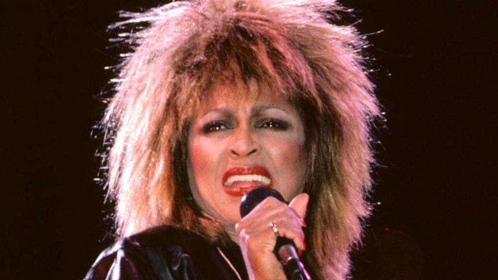 Tina Turner holding microphone