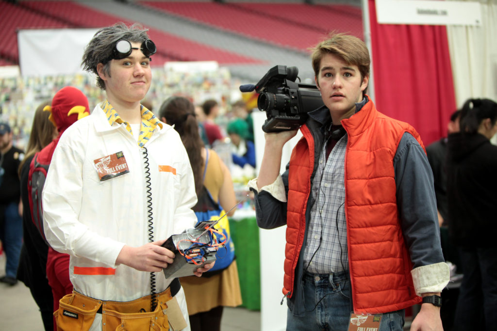 two teens wearing Marty and Doc Brown costumes