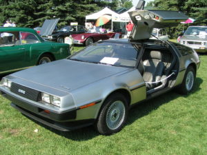 A 1983 DMC Delorean parked on the grass